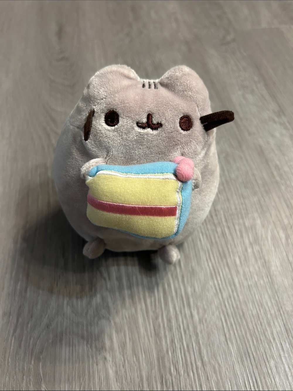 Pusheen Gray Plush Cat Holding Yellow Slice with Blue Trim and Pink Accent
